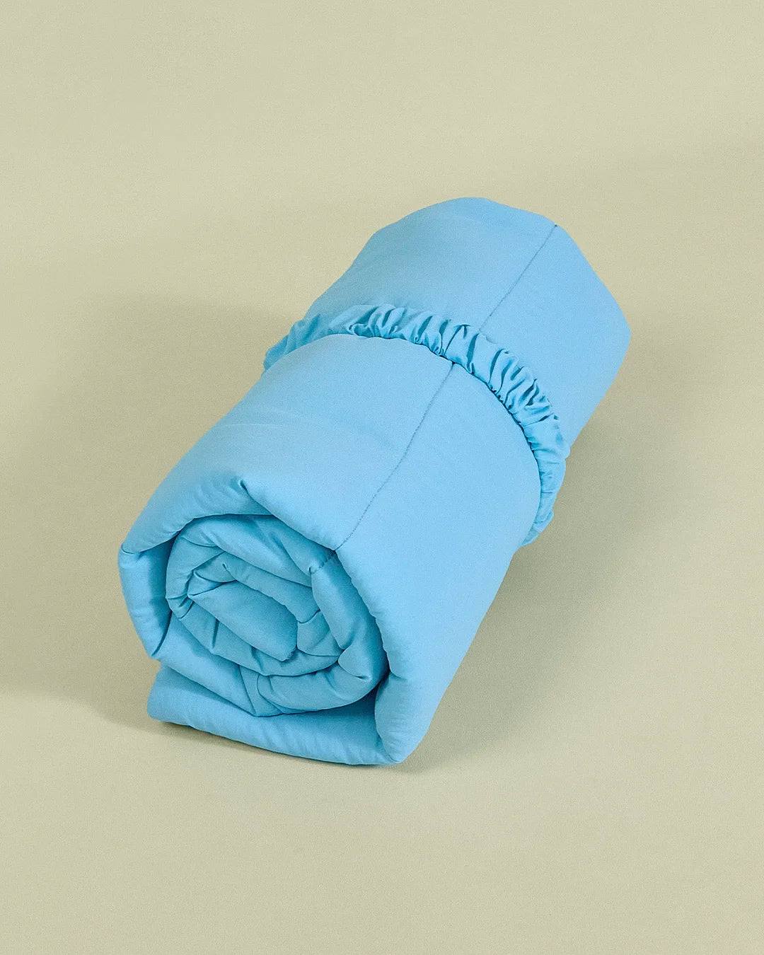 Blue reversible dog travel mat rolled up with elastic carry handle