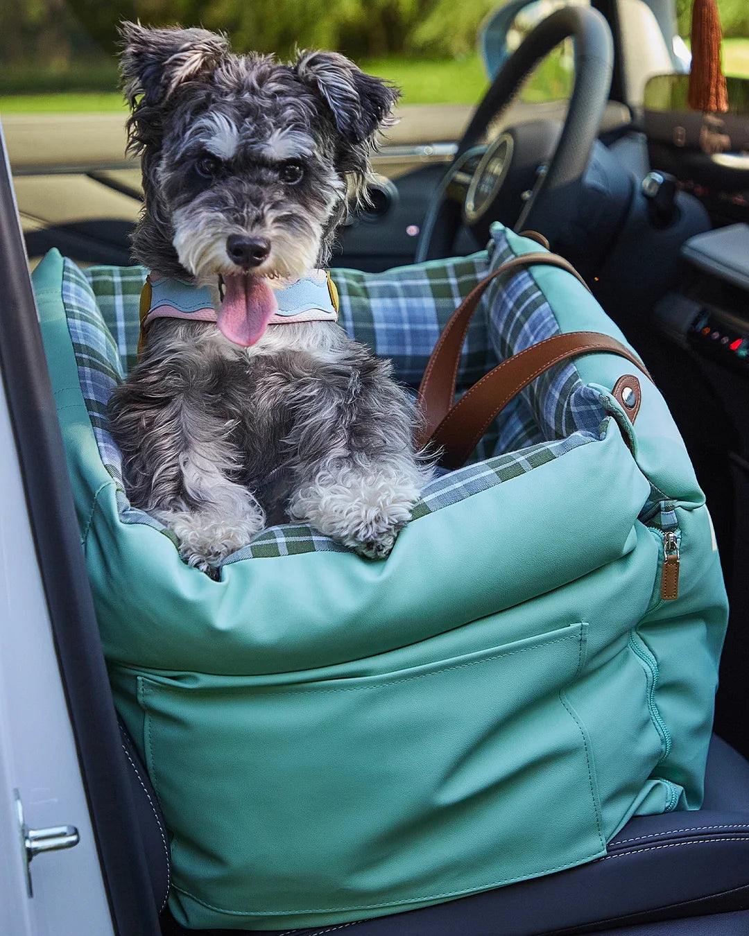Stylish green plaid dog booster seat made of water-resistant faux leather for family road trips, also comfortable for small cats.