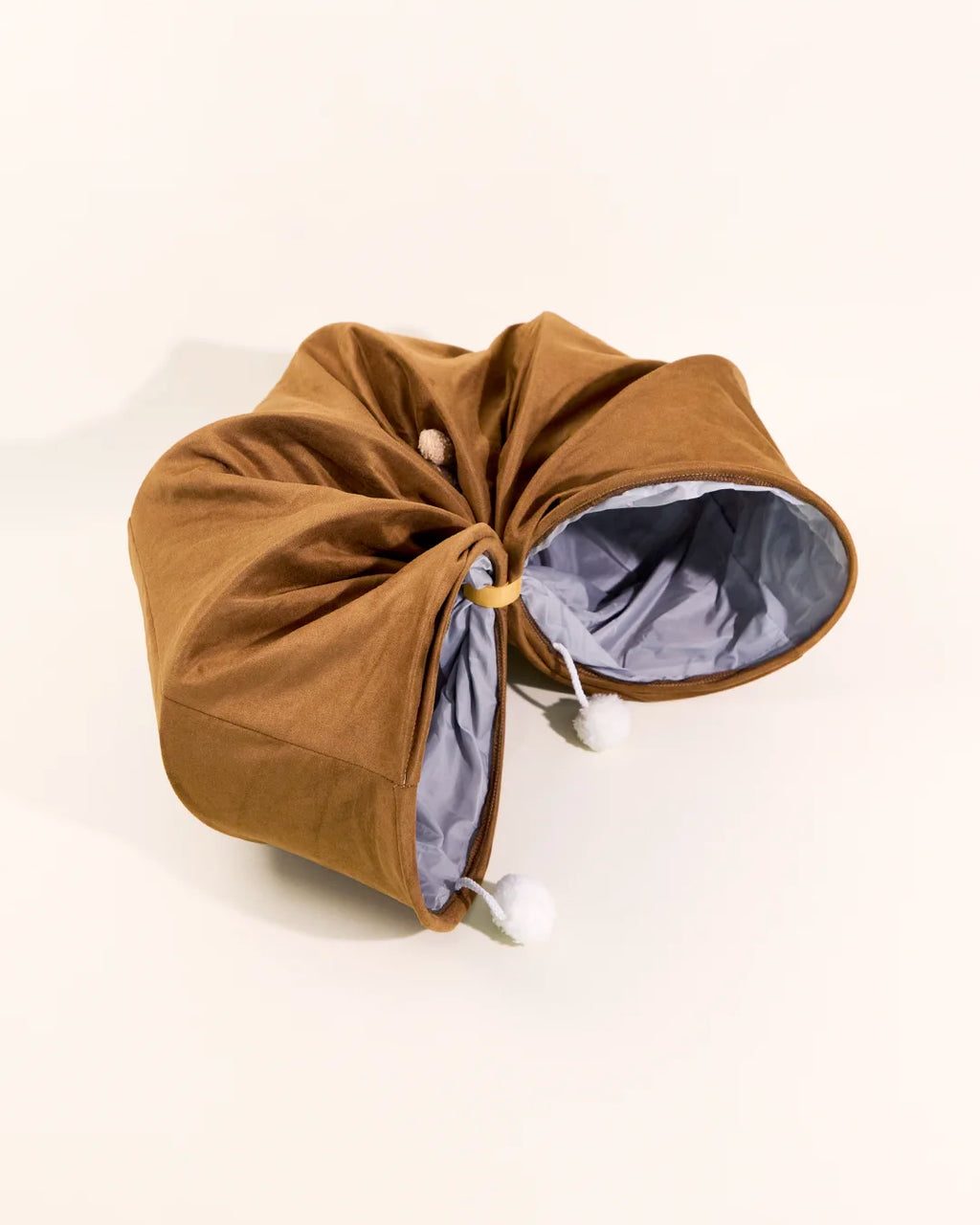 Foldable CharPaw plush cat tunnel tied up for easy storage and space saving