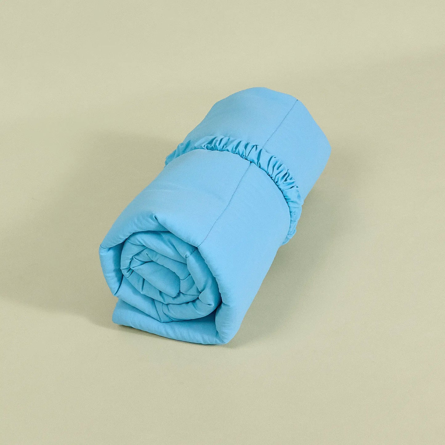 Blue reversible dog travel mat rolled up with elastic carry handle