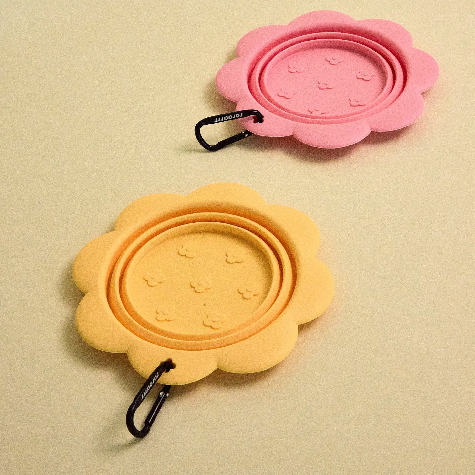 collapsible flower pet bowl shown folded with a carabiner clip attached