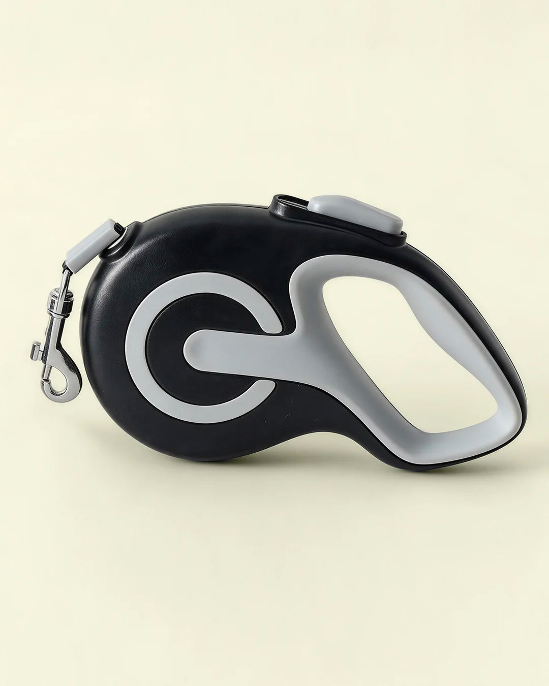 Black colored retractable dog leash shown in a flat lay product photo