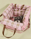 Cozy pink plaid dog car seat with plush supportive padding, creating a calming travel nest that fits puppies and small cats.