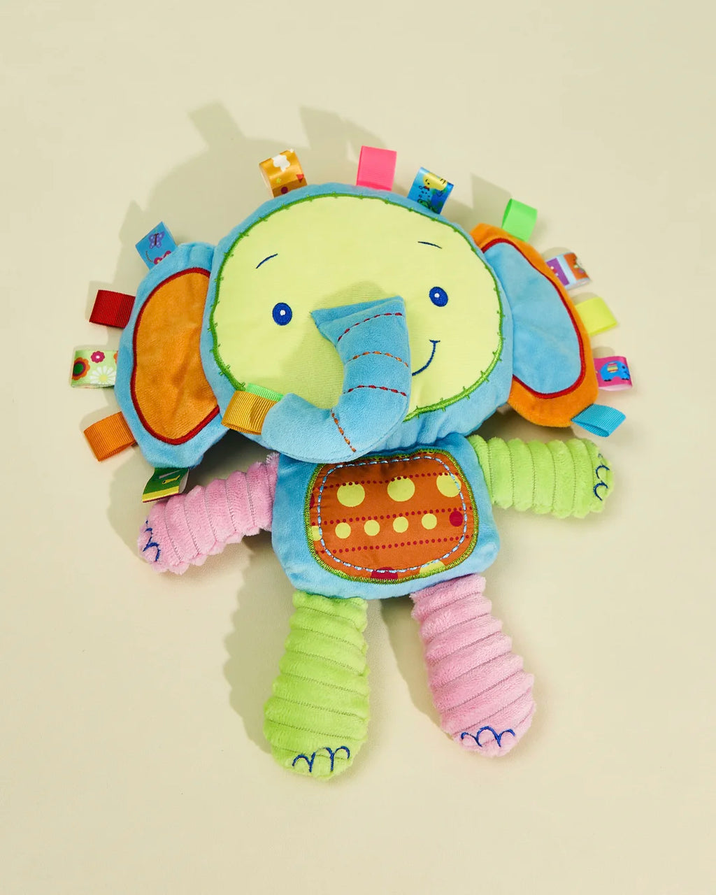 Front view of blue elephant plush dog toy with sensory tags